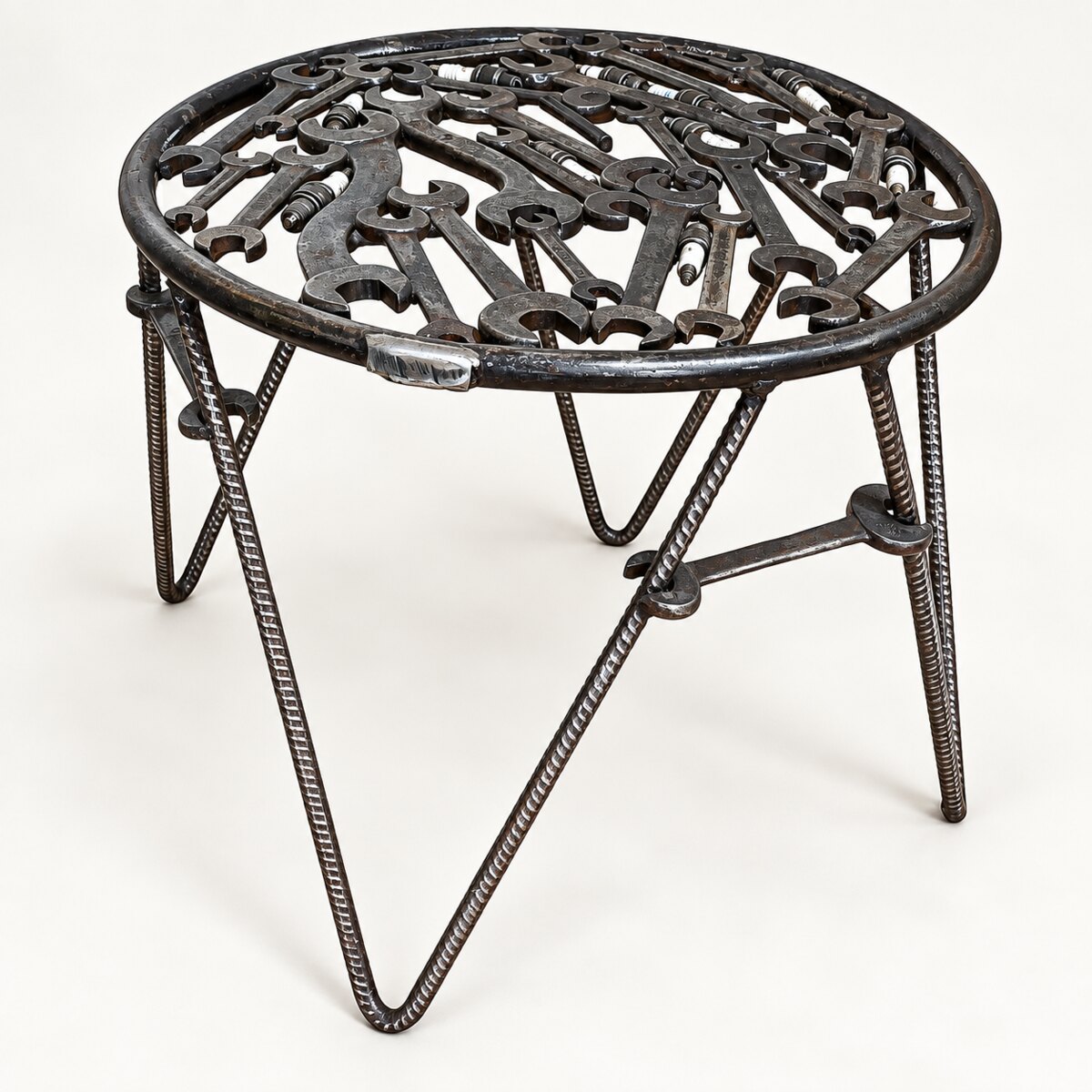 Workshop stool with a top made from reclaimed spanners